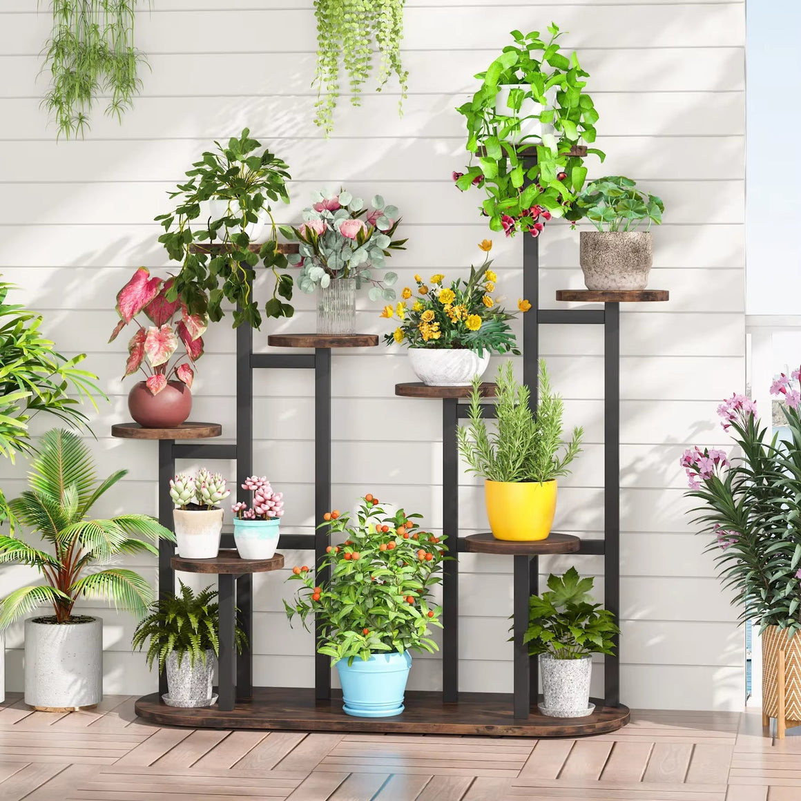 Wooden tiered plant stand with multiple shelves holding potted plants in a bright corner